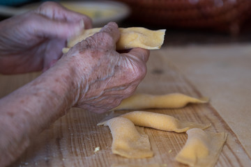 Hands making ravioli pasta