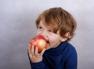 boy eating red Apple