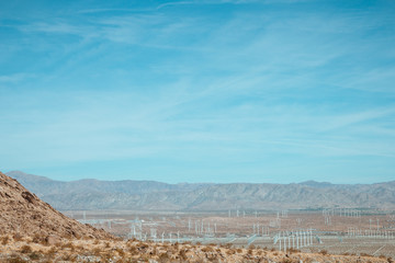 Fototapeta na wymiar Wind generator farm against the blue sky and beautiful landscape