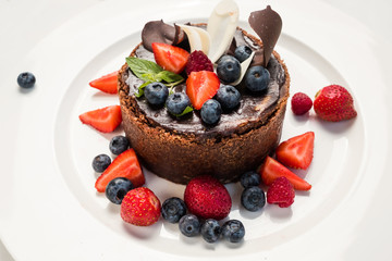 dessert masterpiece sweet cake confectionery concept. chocolate tiramisu with berries. photo for restaurant menu.