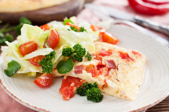 Spicy Omelette with ham, tomatoes, pepper, cheese and herbs