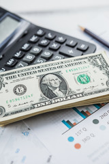 Calculator with american dollars on the wooden table background, finance concept