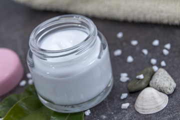 cosmetic cream on a dark background with decoration