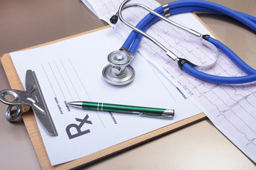 RX prescription, stethoscope, Red heart and pils on white background