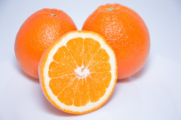 Close-up view of fresh oranges isolated on white background.