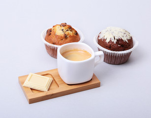 Classic espresso in white cup with homemade cake and chocolate on white background.