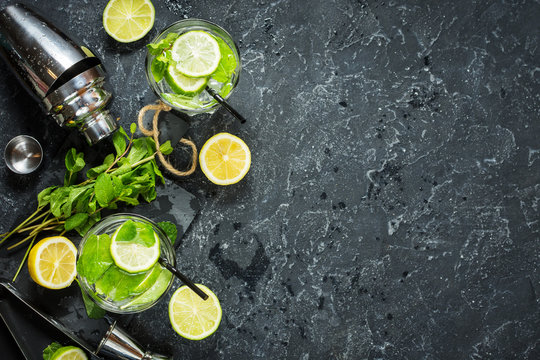 Mojito Cocktail With Lime And Mint In Highball Glass On A Stone Table. Drink Making Tools And Ingredients For Cocktail. Copy Space