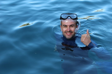 Diver giving a thumbs up after an immersion