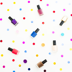 Obraz premium Beauty composition with bright nail polish on white background. Flat lay, top view. Beauty blog concept