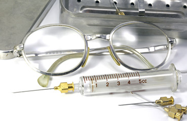 old fashioned vintage style glasses of a doctor and the syringe in glass material