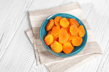 Useful dried apricots in the plate. Copy Space. The concept is healthy food, diet, vegetarianism.