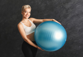 Fitness woman training with fitness ball indoors