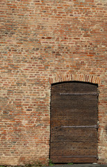 wall of bricks and an old wooden door