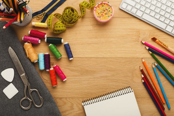 Workspace of fashion designer, top view