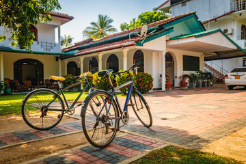 Two old bikes standing against the house in Polonnawuwa, Sri Lanka