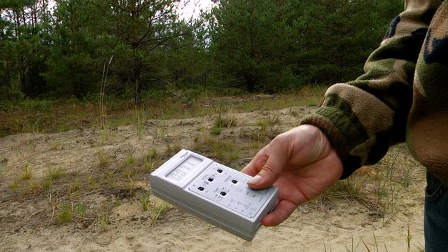 A man holding a dosimeter. Radiation measurement by dosimeter. Chernobyl. Radiation area
