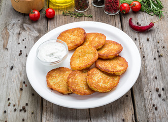 Fried potato pancakes on the old wooden background
