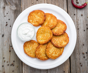 Fried potato pancakes on the old wooden background