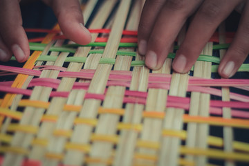 Fototapeta premium Closeup to hand of Thai students grade 4 in primary school are weaving pattern thai.