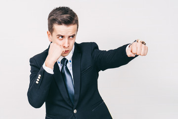 Young handsome man in suit standing in a fighting stance.