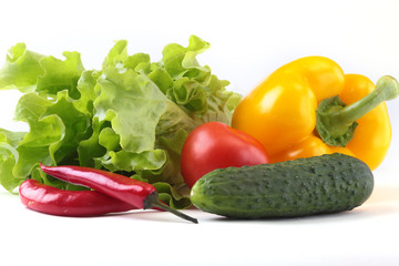 Assorted vegetables, fresh bell pepper, tomato, chilli pepper, cucumber and lettuce isolated on white background. Selective focus.