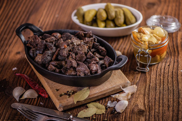 braised beef and lamb meat, liver, lungs and heart dish in black iron cast heavy dish