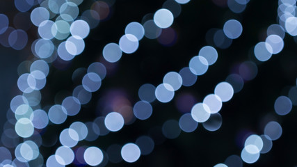 blue bokeh on a dark background.