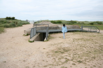 Normandie bunker from World War II with person touring