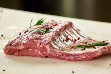 Pork ribs with garnish. Raw pork ribs with side dish.