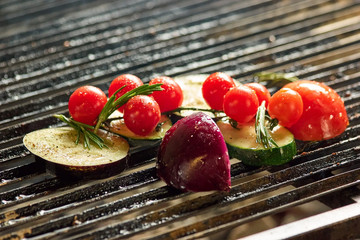 Grilling vegetables. Grilling courgette, zucchini, tomatoes and red onion.
