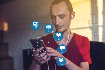 Man uses the phone for entertainment and communication on the Internet. Concept of social network and media
