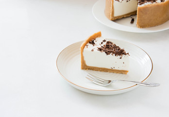 Homemade Cheesecake with chocolate and a cup of coffee on a white background.