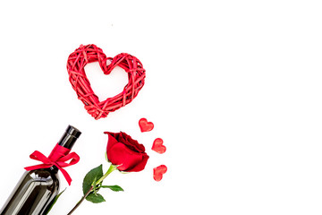 Fototapeta na wymiar Wine and rose for Valentine's day on white background top view copy space