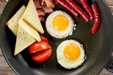Breakfast cooking closeup. Morning breakfast with frying food, closeup.
