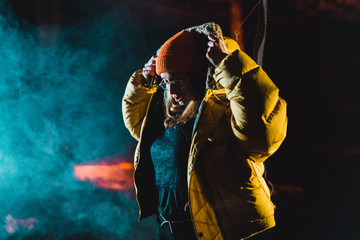 Woman putting on hood of jacket
