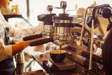 Foto auf Acrylglas barista make coffee latte art with coffee espresso machine in coffee shop cafe in vintage color tone © chayathon2000