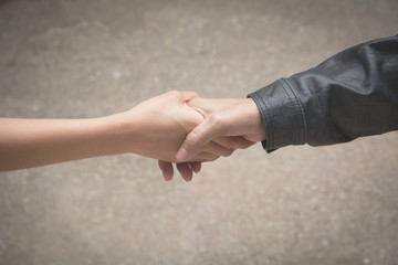 Friend shaking hands together at outdoor. Hand shake between colleagues. Friendship and teamwork concept.