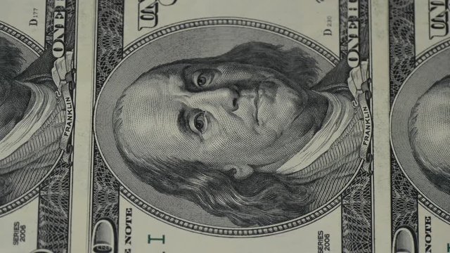 One hundred dollar bills. The motion camera slider. Macro photography of banknotes. Portrait of Benjamin Franklin close-up.
