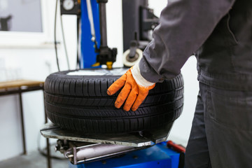 Auto mechanic taking tire. 