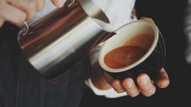 barista make coffee latte art with coffee espresso machine in coffee shop cafe in vintage color tone
