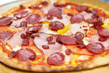 Freshly baked juicy salami pizza. Close up baked salami pizza.