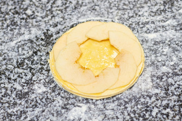 First layer of apple tart. Uncooked apple pie.