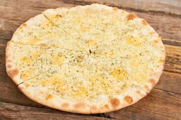 Top view sliced cheese pizza. Cut cheese pizza on the table.