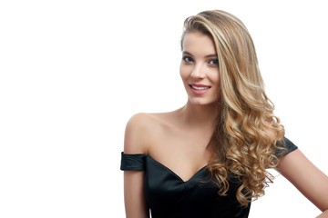 Portrait of a beatiful smiling girl with blonde curly hair in a nice evening dress with an open...