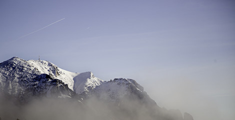 Fototapeta na wymiar Snowy mountains fog