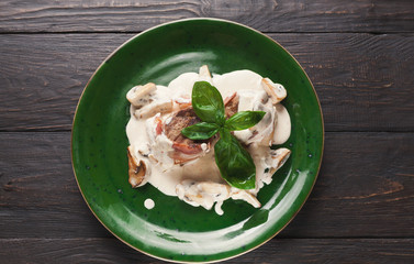 Meet with mushrooms under cream sauce