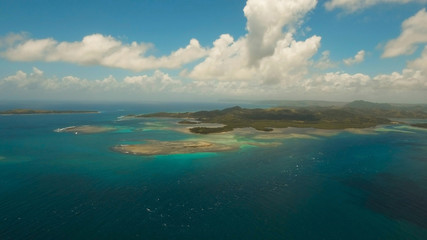 Aerial view: beach, tropical island, sea bay and lagoon, Siargao. Tropical landscape hill, clouds and mountains rocks with rainforest. Azure water of lagoon. Shore Landscape Bay. Aerial video.Seascape
