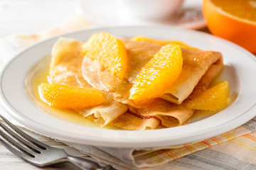 Crepe suzette, traditional french dessert with thin pancakes and orange sauce.