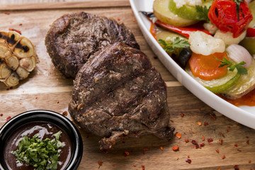 beef medallions grilled with vegetables on the board tenderloin mignon