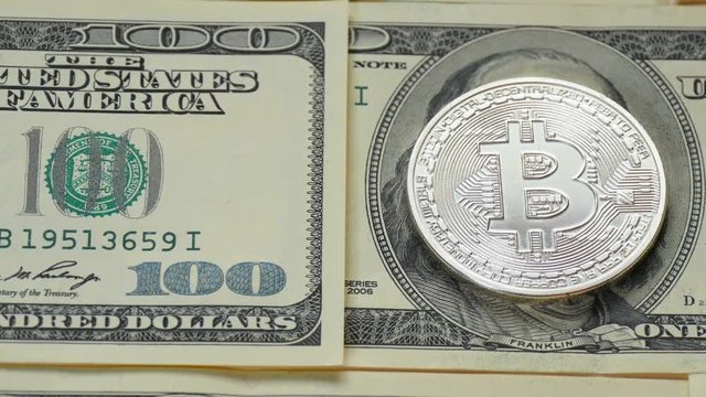 Bitcoin and dollar. The coin of crypto currency replaced the image of Franklin on a hundred-dollar bill.